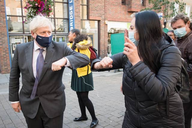 Prime Minister Boris Johnson meets shoppers and shopkeepers during a visit to his constituency in Uxbridge, west London. Photo: PA