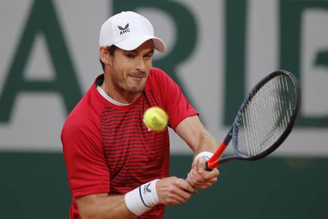 Early exit: Britain's Andy Murray plays a shot in his heavy defeat against Switzerland's Stan Wawrinka. (AP Photo/Christophe Ena)