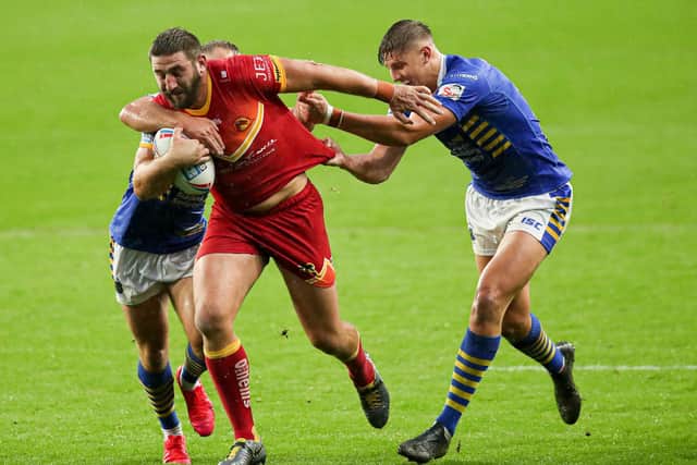 Catalans Dragons' Julian Bousquet is tackled by Sam Walters. Picture: Paul Currie/SWpix.com.