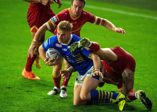 Alex Sutcliffe is held on the try line by the Catalans Dragons' defence. Picture: Bruce Rollinson.