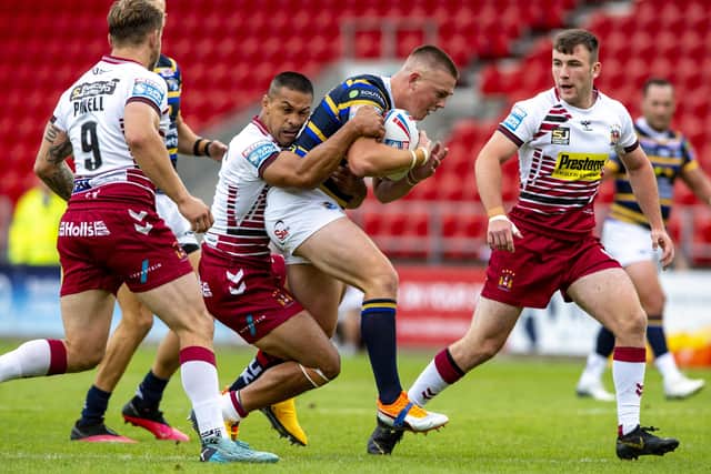 Callum McLelland is held by Willie Isa during Leeds Rhinos' clash with Wigan in August.
 Picture: Bruce Rollinson.
