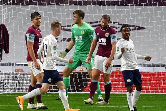 NEW ROLE: Raheem Sterling, right, celebrates putting Manchester City ahead in Wednesday night's Carabao Cup clash at Burnley in which the England international again started upfront. Photo by Paul Ellis - Pool/Getty Images.