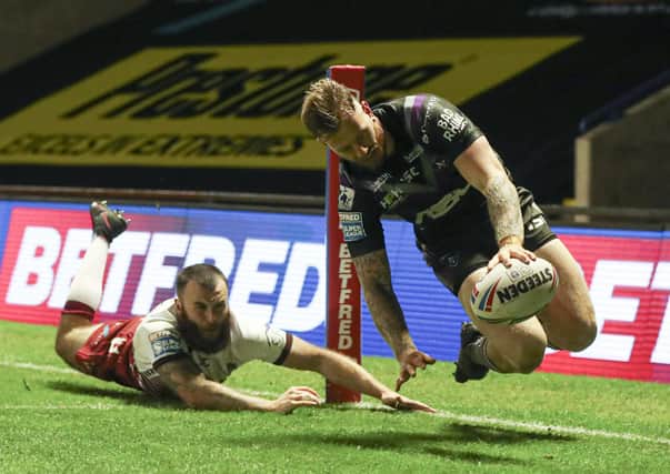 Looking good: Tom Johnstone of Wakefield Trinity scores a try in the defeat by Wigan. Picture by Paul Currie/SWpix.com