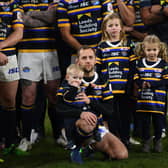 Rob Burrow on the pitch with his wife Lindsey and children Macy, Maya and Jackson.