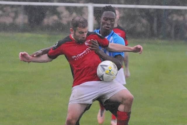 Robert Evans of Horbury Town is marked closely by Jovanni Sterling of Carlton. Picture: Steve Riding.