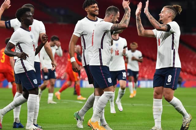 PUT IT THERE: Leeds United's Kalvin Phillips, right, celebrates with England scorer Danny Ings, second right, after the Southampton striker nets from his corner. Photo by Glyn Kirk - Pool/Getty Images.