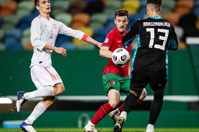 FLYING THE FLAG: Leeds United Spanish international centre-back Diego Llorente, left, chasing down Portugal's Diogo Jota in Wednesday's friendly in Lisbon. Photo by CARLOS COSTA/AFP via Getty Images.