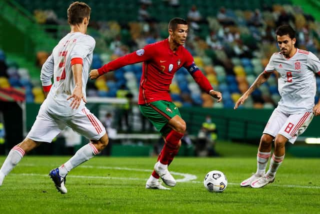 PRAISE: For Leeds United's Spanish international centre-back Diego Llorente, left, pictured in combat with Portugal's Cristiano Ronaldo in last Wednesday's friendly in Lisbon. Photo by CARLOS COSTA/AFP via Getty Images.