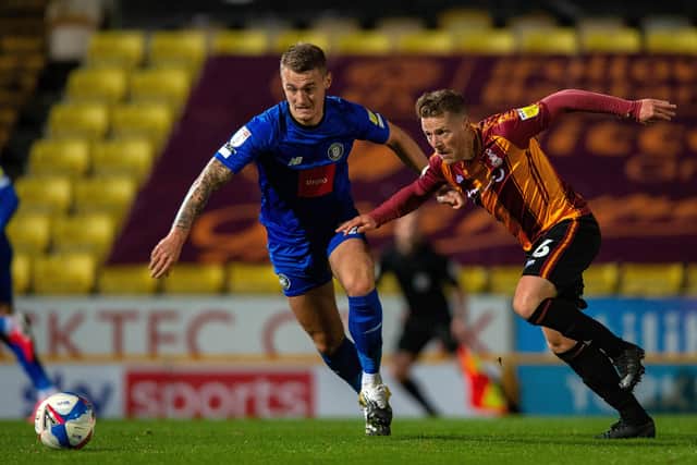 Harrogate's William Smith and Bradford's Billy Clarke battle for the ball at Valley Parade. Picture: Bruce Rollinson