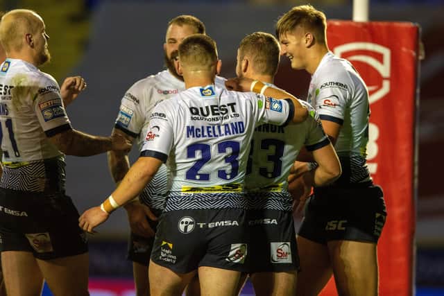 All smiles: Sam Walters is congratulated after scoring Rhinos' first try. Picture Bruce Rollinson