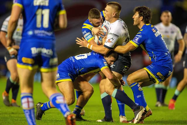Blue wall: Callum McLlelland is held by the Warrington defence.
 Picture Bruce Rollinson