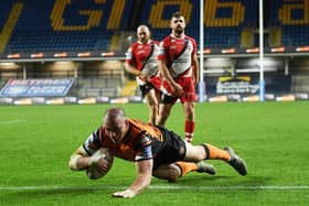 Grant Millington scores for Tigers against Salford. Picture by Jonathan Gawthorpe.