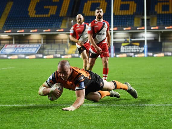 Grant Millington scores for Tigers against Salford. Picture by Jonathan Gawthorpe.