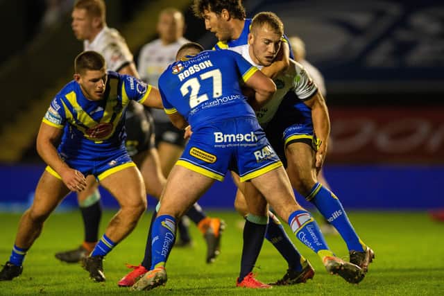 Jarrod O'Connor is held by Warrington's Ellis Robson and Stefan Ratchford.
 Picture: Bruce Rollinson.