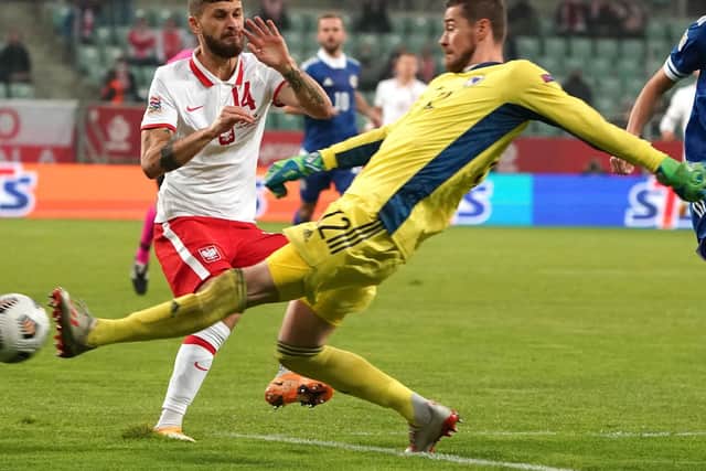 HAILED: Leeds United's Polish international midfielder Mateusz Klich challenges Bosnia-Herzegovina's goalkeeper Ibrahim Sehic. Photo by JANEK SKARZYNSKI/AFP via Getty Images.