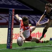 Super score: St Helens' Tommy Makinson (left) scores a stunning try - part of his hat-trick against Wakefield. Picture: Martin Rickett/PA Wire.