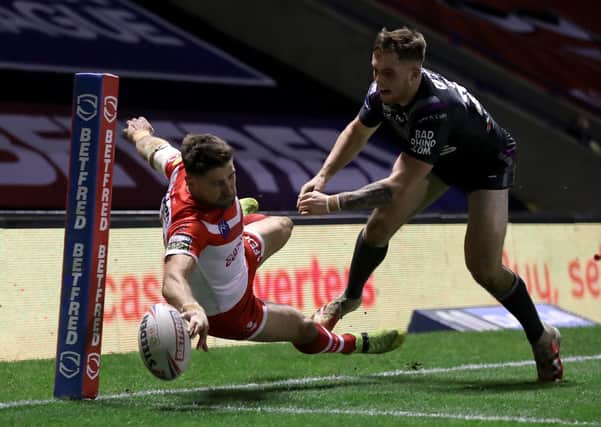 Super score: St Helens' Tommy Makinson (left) scores a stunning try - part of his hat-trick against Wakefield. Picture: Martin Rickett/PA Wire.