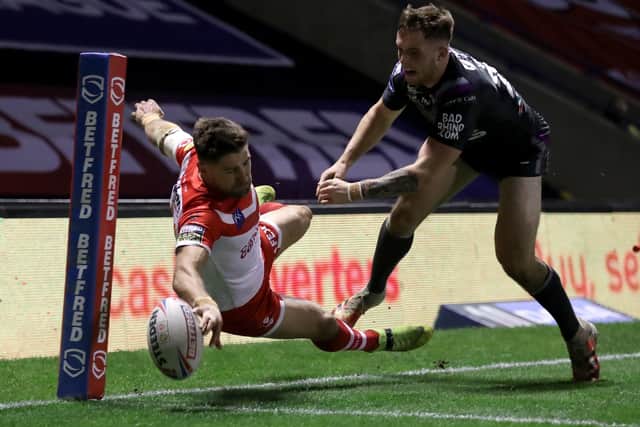 Super score: St Helens' Tommy Makinson (left) scores a stunning try - part of his hat-trick against Wakefield. Picture: Martin Rickett/PA Wire.