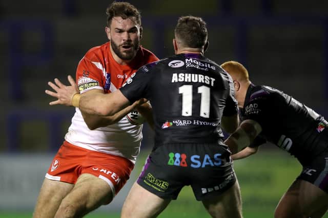One way traffic: St Helens' Alex Walmsley (left) is tackled by Wakefield Trinity's Matty Ashurst (centre) and Josh Wood. Picture Martin Rickett/PA Wire.