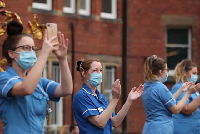 Hospital workers outside Leeds General Infirmary to salute local heroes during the Clap for Carers initiative to recognise and support NHS workers and carers fighting the coronavirus pandemic. Photo: PA