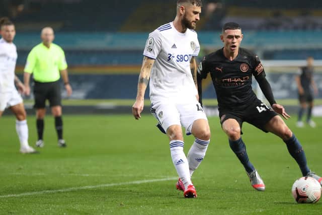 AUTOMATIC PICK: Leeds United midfielder Mateusz Klich, pictured in battle with Manchester City's Phil Foden, is now one of the first names on the Whites team sheet. Photo by Catherine Ivill/Getty Images.