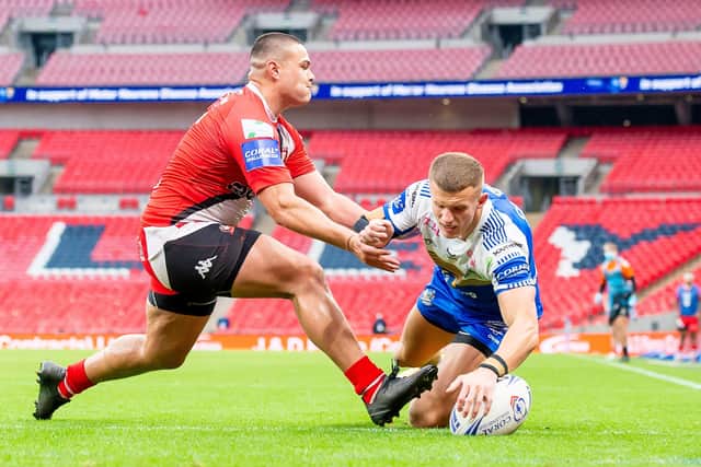Salford's Tui Lolohea can't prevent Leeds Rhinos' Ash Handley from scoring his first try. Picture: Allan McKenzie/SWpix.com.