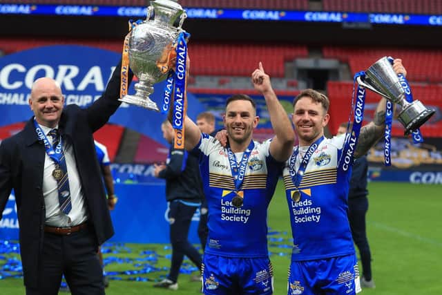 Richie Myler, right, celebrates with the Lance Todd Trophy as Richard Agar and Luke Gale show off the Challenge Cup. Picture by Mike Egerton PA.