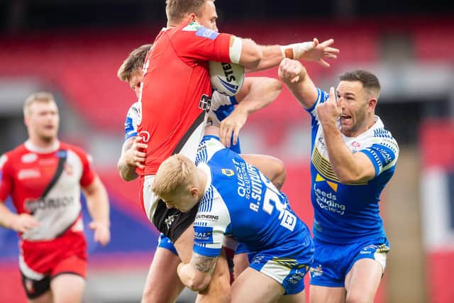 Salford Red Devils captain Lee Mossop is tackled by Leeds Rhinos' Alex Mellor, Alex Sutcliffe and Luke Gale during the Challenge Cup final on Saturday. Picture: Allan McKenzie/SWpix.com.
