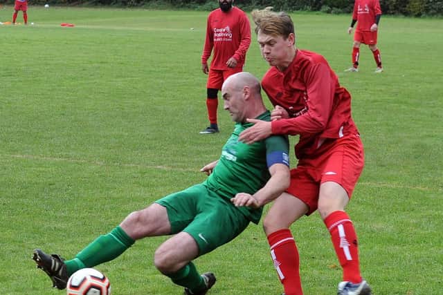 Lee Coleman of Beeston St Anthony's clears under pressure from Edward Golder of Leeds Independent. Picture: Steve Riding.