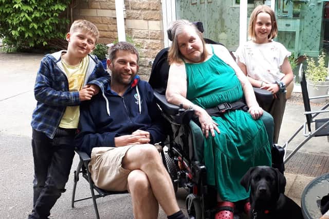 Maggie Wright pictured in May 2019 with son Tom and and grandchildren  Daisy, 11, and Archie, nine, outside the care home in north Leeds.
