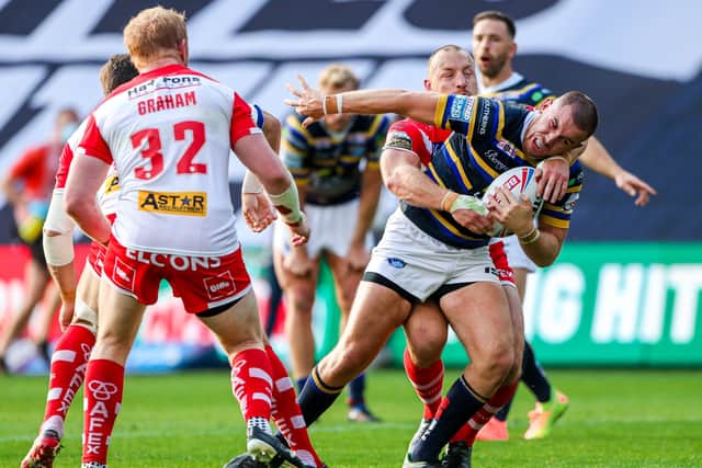 Leeds Rhinos' Cameron Smith is tackled by St Helens' James Roby. Picture: Allan McKenzie/SWpix.com.