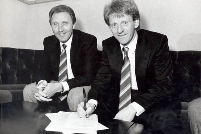 GAME CHANGER: Gordon Strachan signs on the dotted line to join Leeds United from Manchester United on March 23, 1989, joining new boss Howard Wilkinson, left, in dropping down a division. The only way was then up. Photo by YPN.