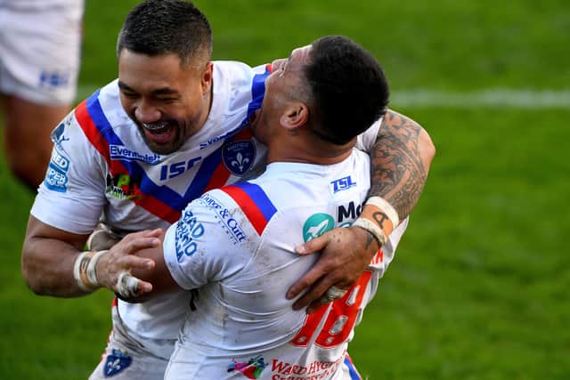Tinirau Arona, of Wakefield Trinity, celebrates with his team-mate Adam Tangata (right) after scoring a try against Hull KR. Picture: James Hardisty/JPIMedia.