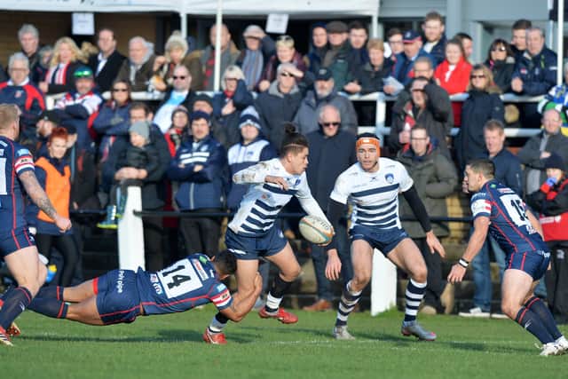On the ball: Jacob Umaga is held by Curtis Wilson while paying for Carnegie against Doncaster. Picture Bruce Rollinson