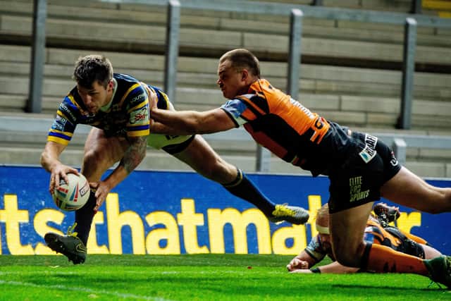 Luke Briscoe heads in for the Rhinos' fourth try against Castleford. Picture: Bruce Rollinson.