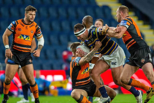 Rhinos' Bodene Thompson is tackled by Tigers forwards Tyla Hepi and Liam Watts. Picture by Bruce Rollinson.