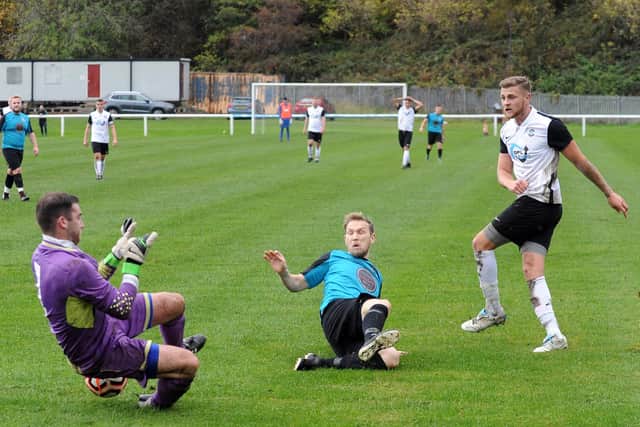 Adam Williams, of Littletown, brings out a sound save from Stanley United goalkeeper, Oliver Corcoran. Picture: Steve Riding.