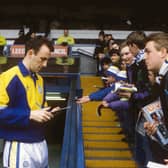 Gary McAllister signs autographs for Leeds United fans at Elland Road.