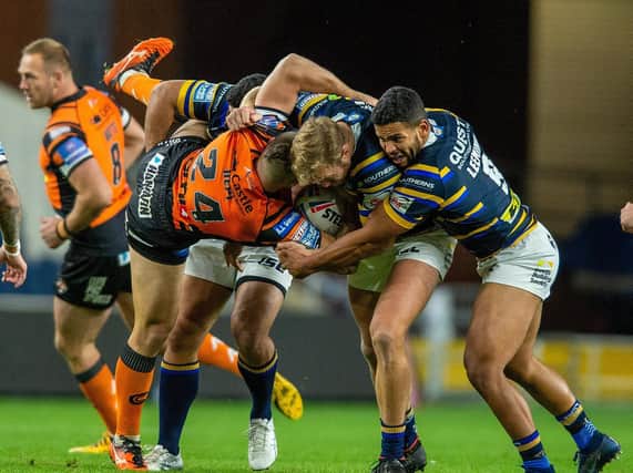 Tigers' Tyla Hepi is upended by the Rhinos defence. Picture by Bruce Rollinson.