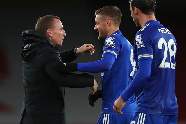 STILL WINNING: Leicester City striker Jamie Vardy hugs boss Brendan Rodgers following the 1-0 triumph at Arsenal in which Vardy returned from injury to bag the only goal of the game. Photo by CATHERINE IVILL/POOL/AFP via Getty Images.