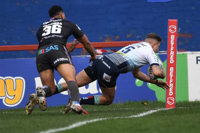 Liam Sutcliffe dives over for one of four Leeds Rhinos tries in the win at Wakefield Trinity. Picture: Jonathan Gawthorpe/JPIMedia.