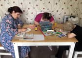A kitchen table is transformed into a painter’s workshop as part of Artlink West Yorkshire’s plan help people access the joy of art.
