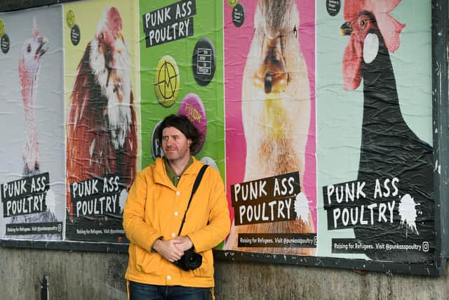 Leeds photographer Angus Macdonald with his Punk Ass Poultry street art, on 100 billboards and poster drum sites across the city, in aid of Leeds Asylum Seekers' Support Network (LASSN). Picture: Jonathan Gawthorpe