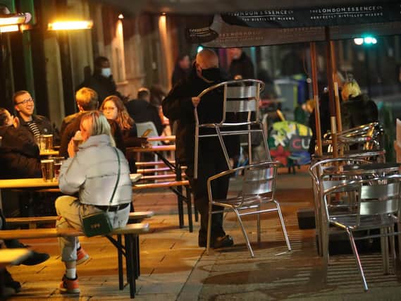 A man puts away chairs outside a bar in Leeds last night, ahead of a national lockdown for England (Photo: Danny Lawson/PA Wire)