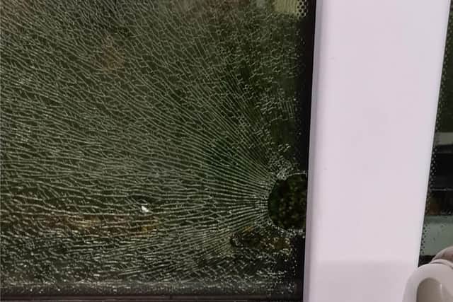 A smashed bus window caused by youths throwing bricks. Photo provided by First Bus.