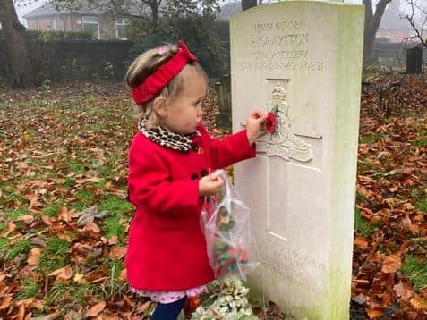 Little Margot King, one, put poppies on the war graves at her local cemetery in Wortley on Remembrance Sunday. Picture sent in by mum Mandy.