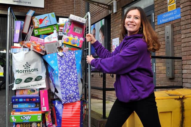 Joanna Parker from Leeds Cares pushing a crate of toys that have been donated to Leeds Childrens Hospital in December 2019.