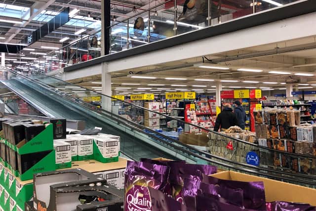 The travelator at a Tesco supermarket in Cambridge is blocked off to close the clothing and general merchandise department, at the start of the first full week of the four week national lockdown in England.