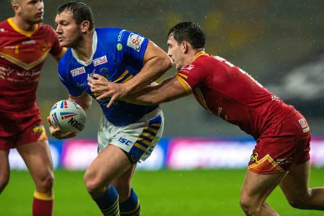 Leeds' Brett Ferres is tackled by Matt Whitley, of Catalans, in September's Super League meeting. Both players could feature on Friday. Picture by Bruce Rollinson.