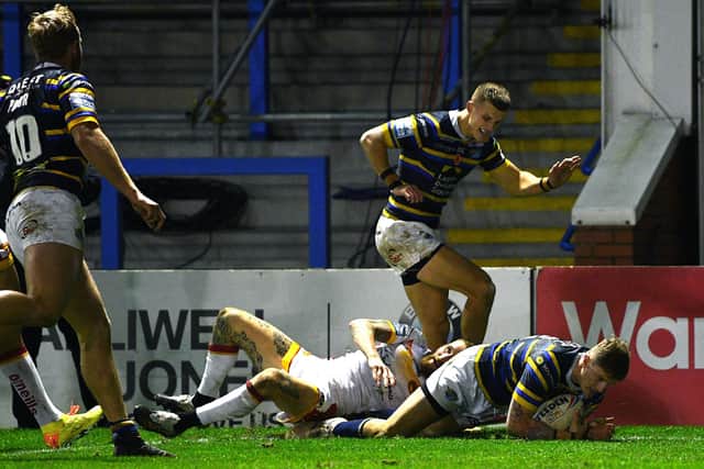 Ray of hope:
Rhinos' Liam Sutcliffe scores his side's second try against the Dragons.
Picture: Jonathan Gawthorpe